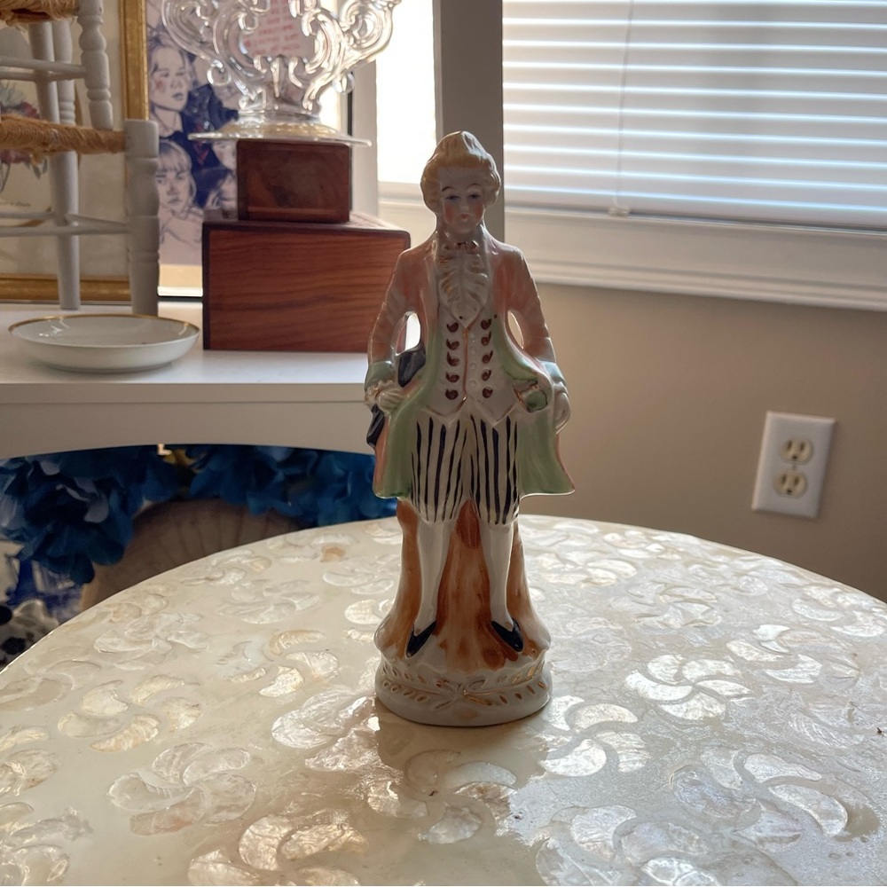 vintage pastel green and orange colonial man porcelain like statue decor
